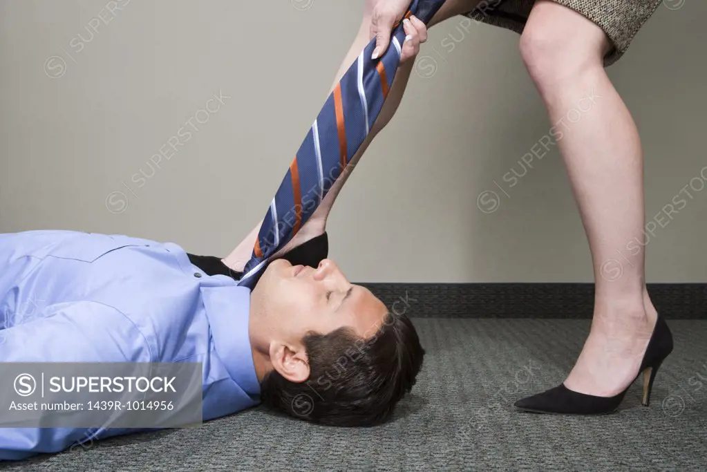 Woman pulling manager's tie