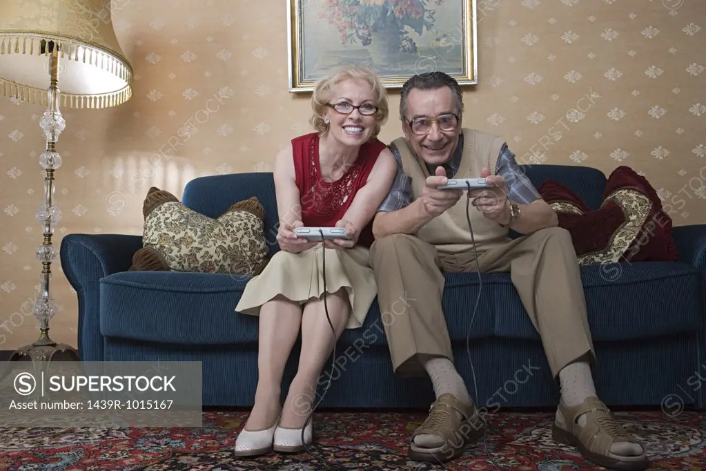 Senior couple playing video game