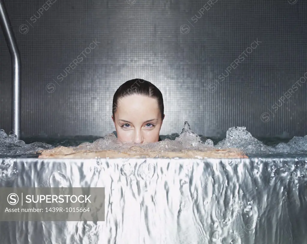 Woman immersing in jacuzzi 