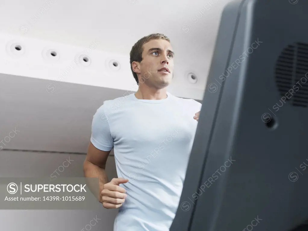 Man on treadmill in health club 