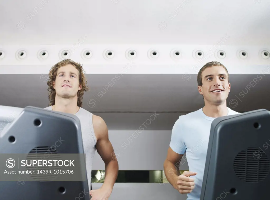 Two men on treadmill in health club