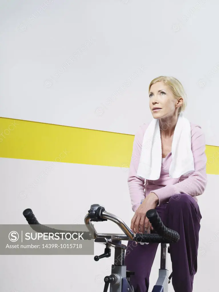Woman on exercise bike in health club