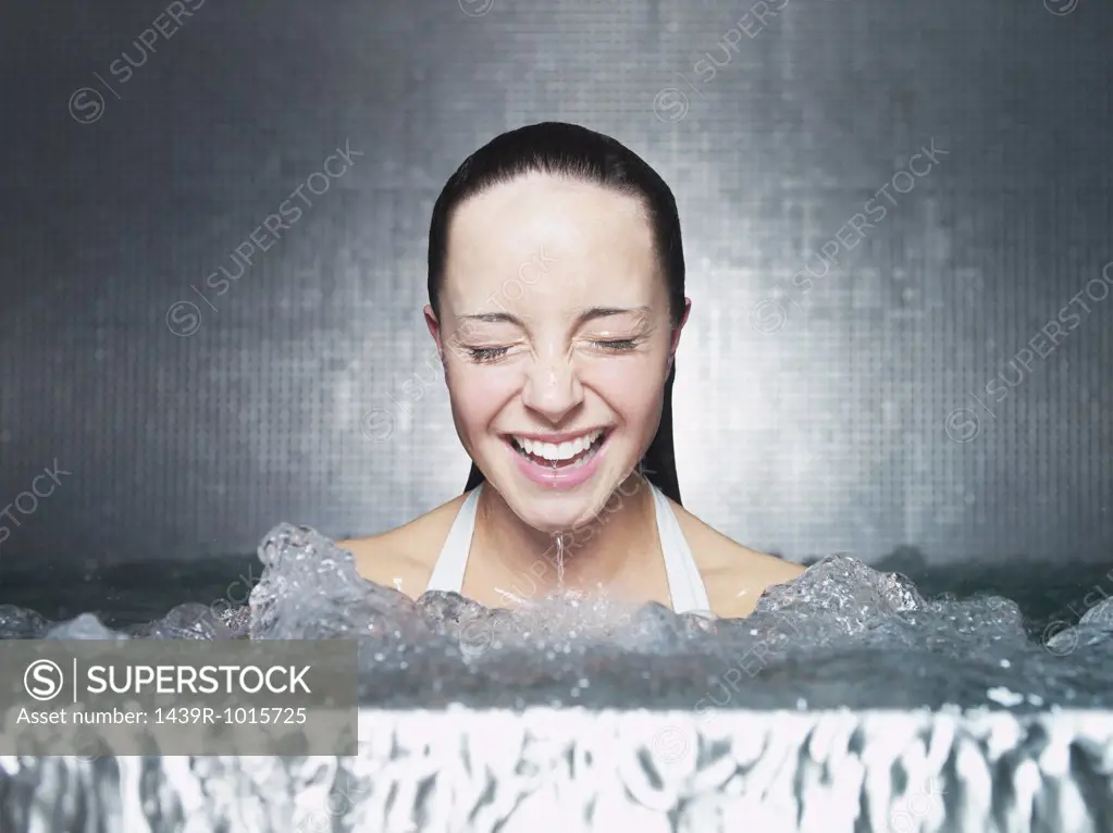 Woman immersing in jacuzzi