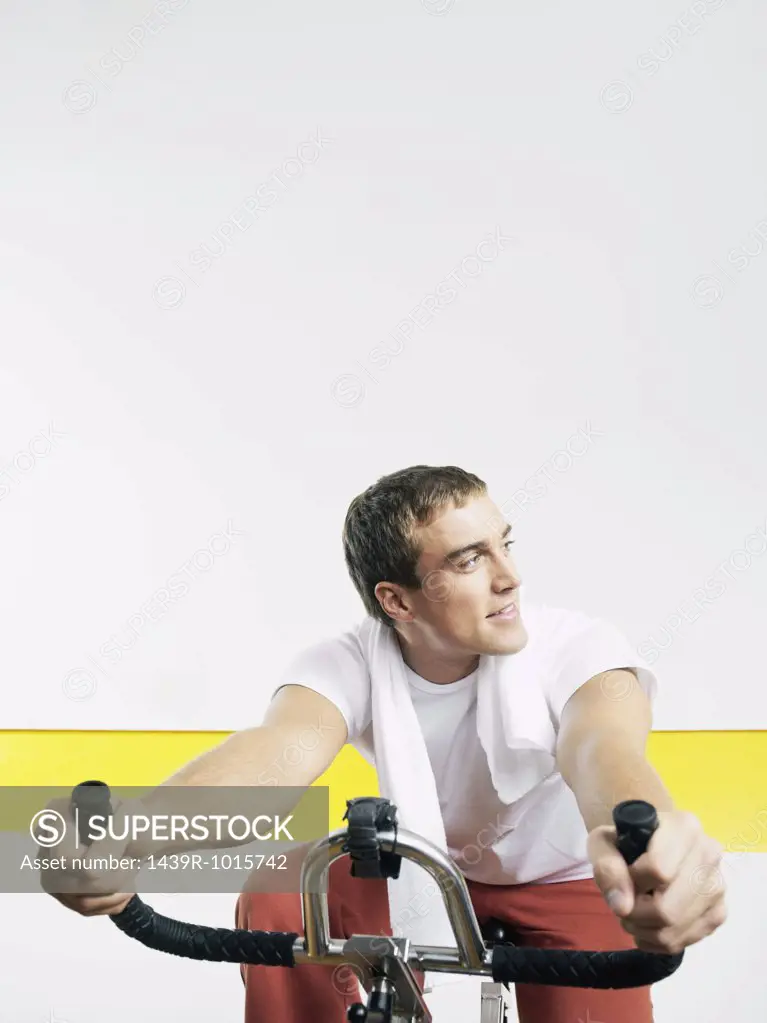 Man on exercise bike in health club