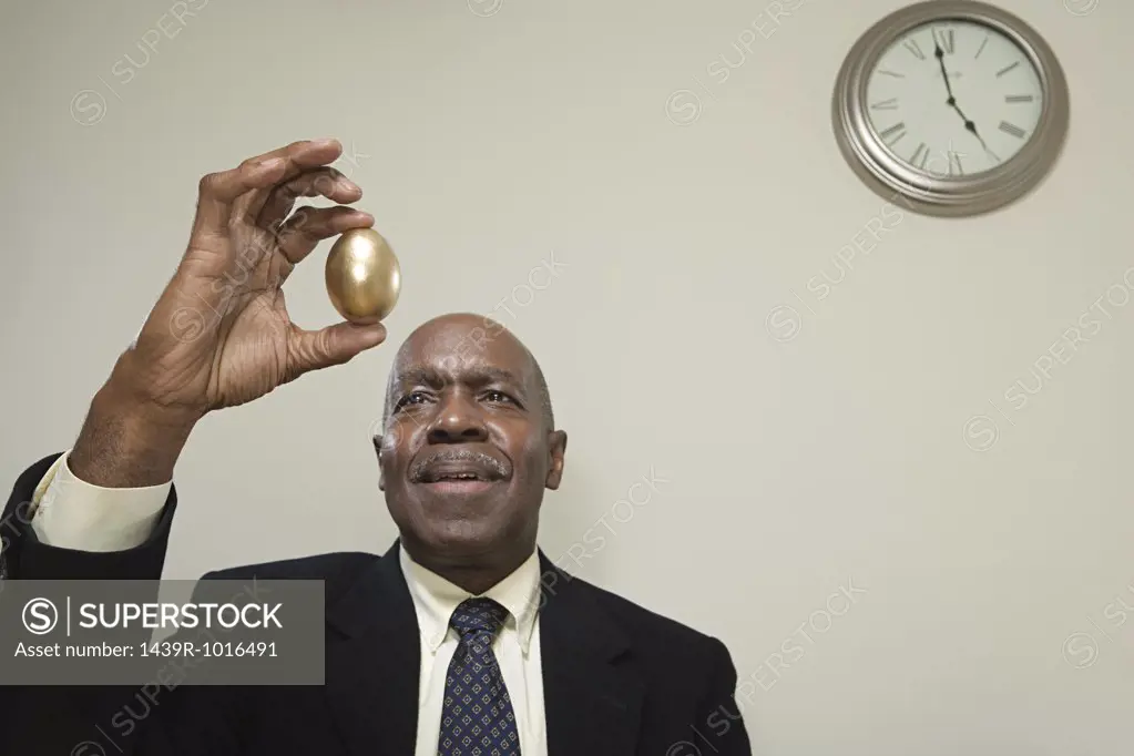 Man holding a golden egg