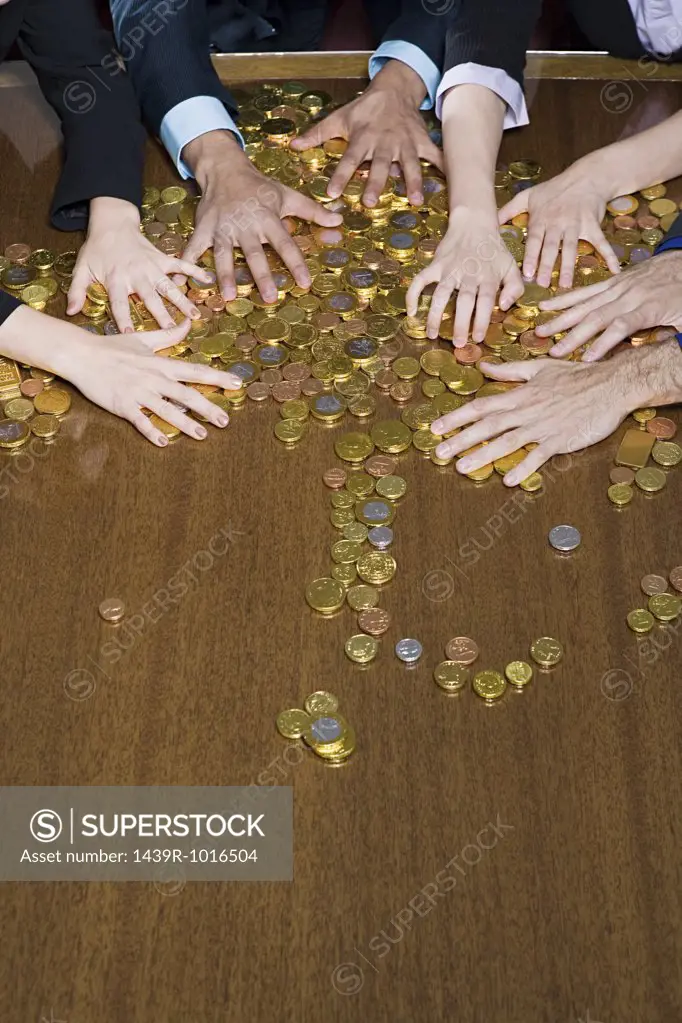 Hands grabbing coins