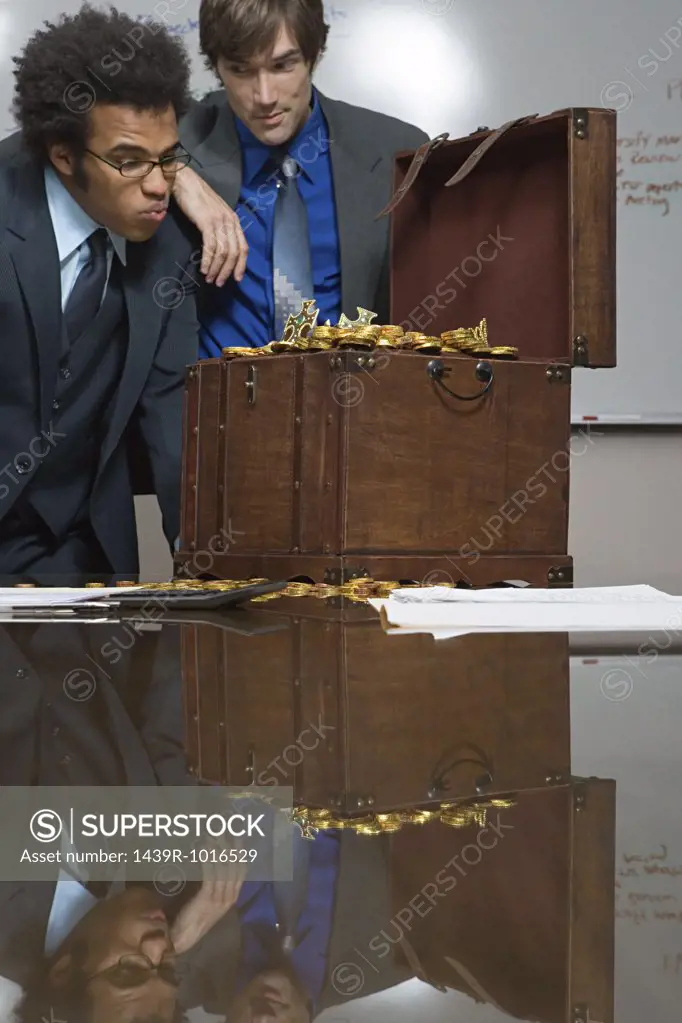 Colleagues looking at a treasure chest