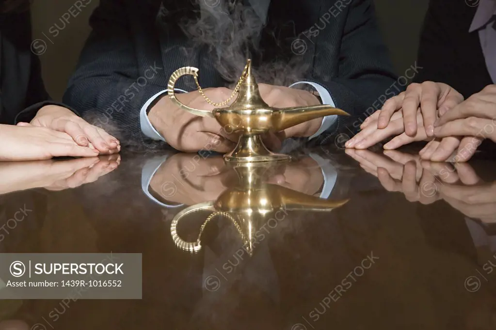 Colleagues around a smoking genie lamp