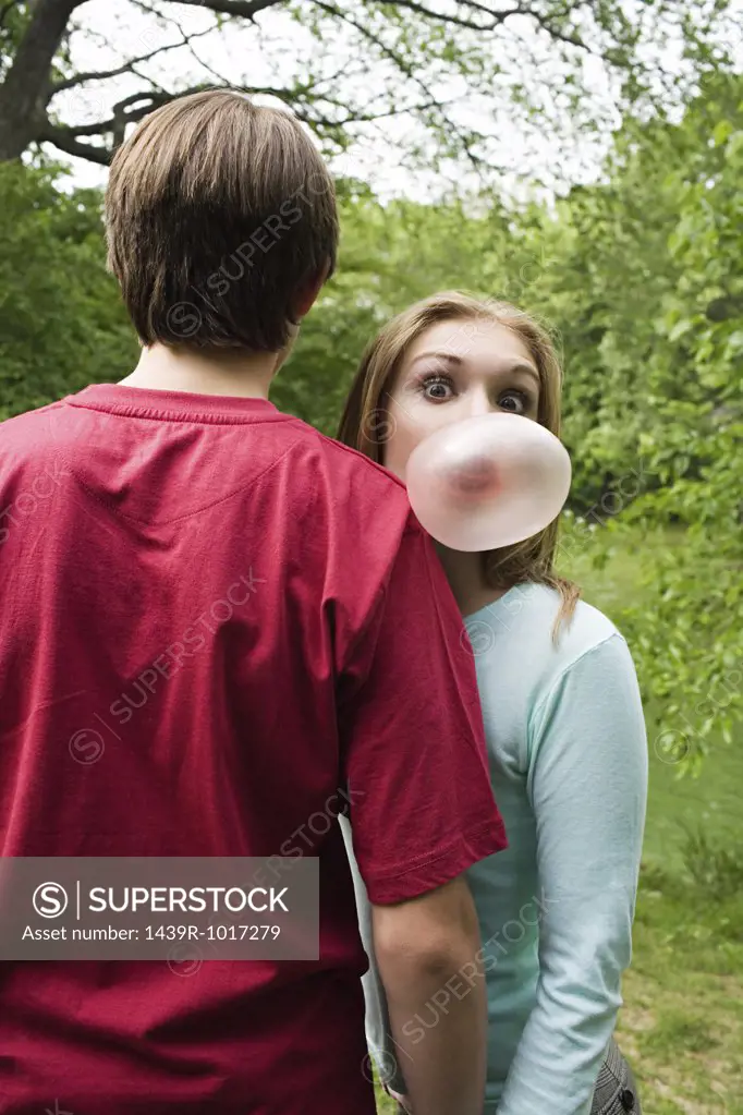 Girl blowing a bubble gum bubble