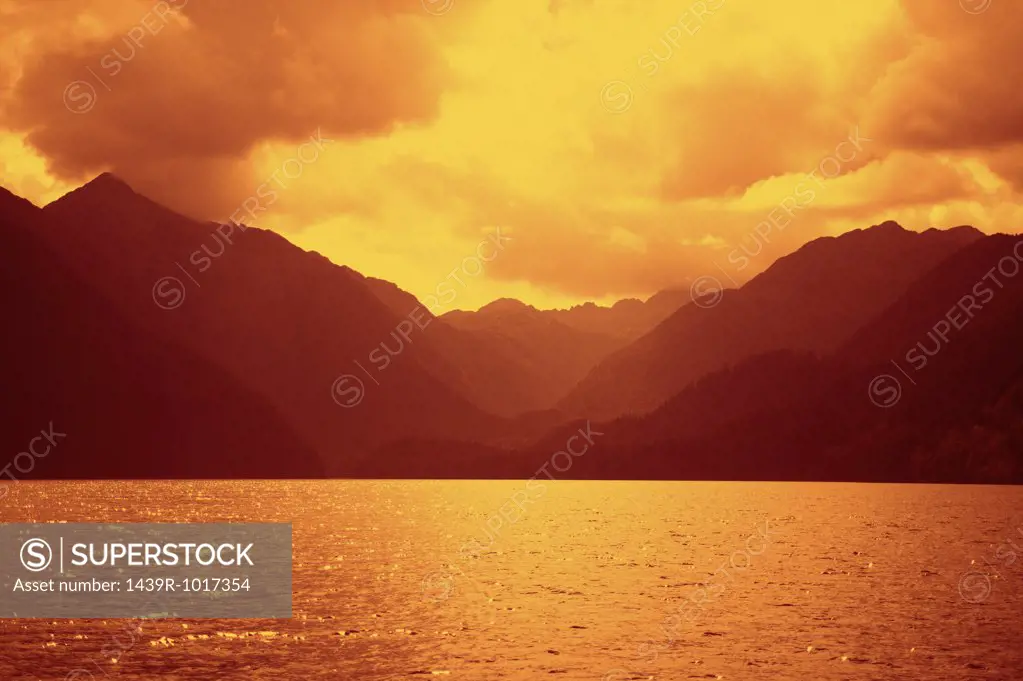 Mountains and water glowing in sunset