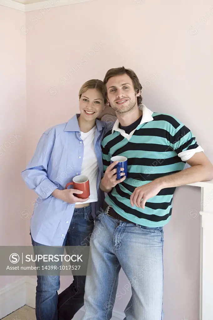 Young couple with coffee cups