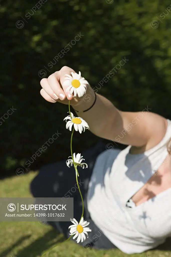 Woman holding a daisy chain