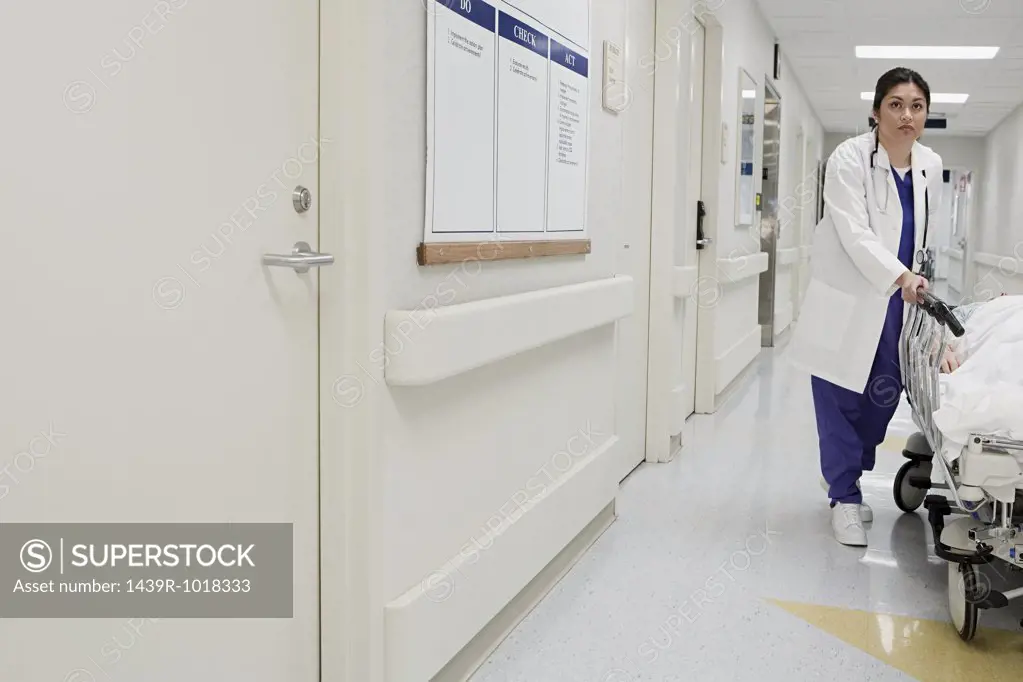 Doctor taking patient down corridor