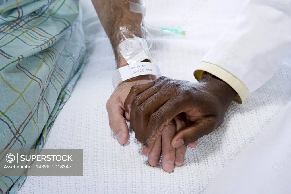 Doctor holding patients hand