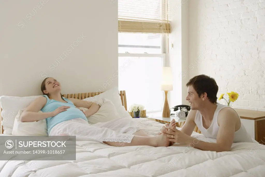 Man massaging pregnant partners foot