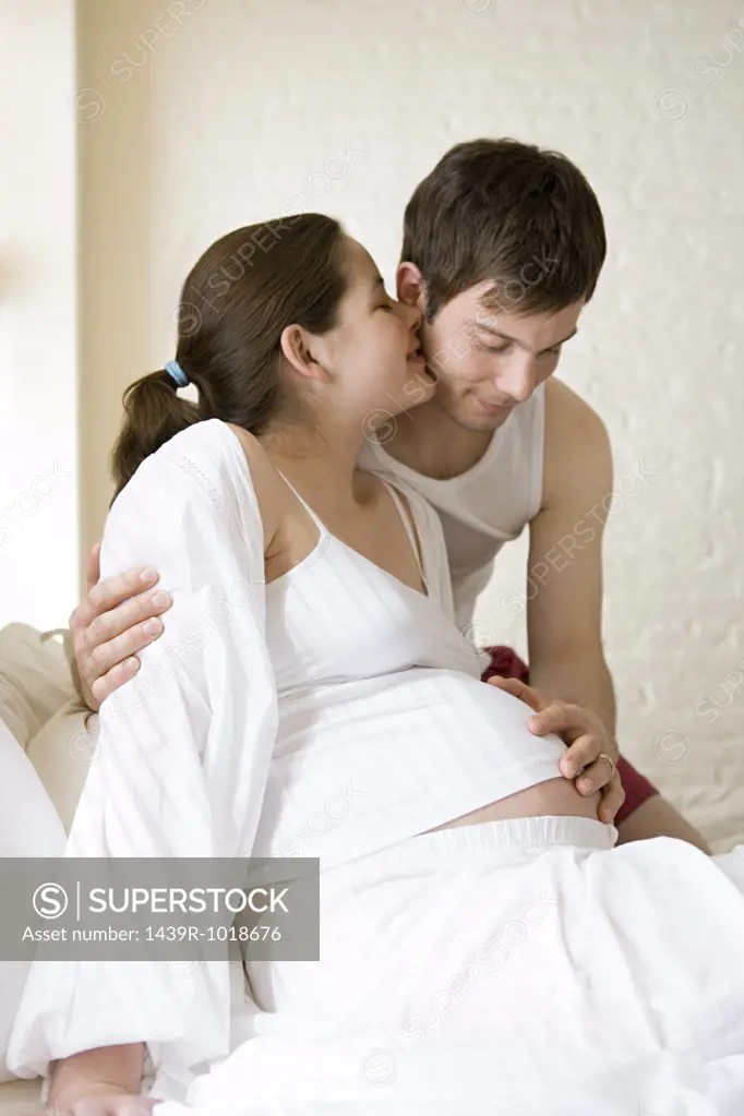 Man touching pregnant partners stomach