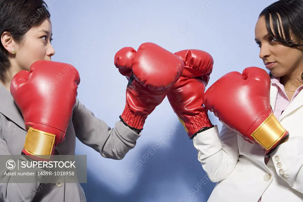Two businesswomen boxing