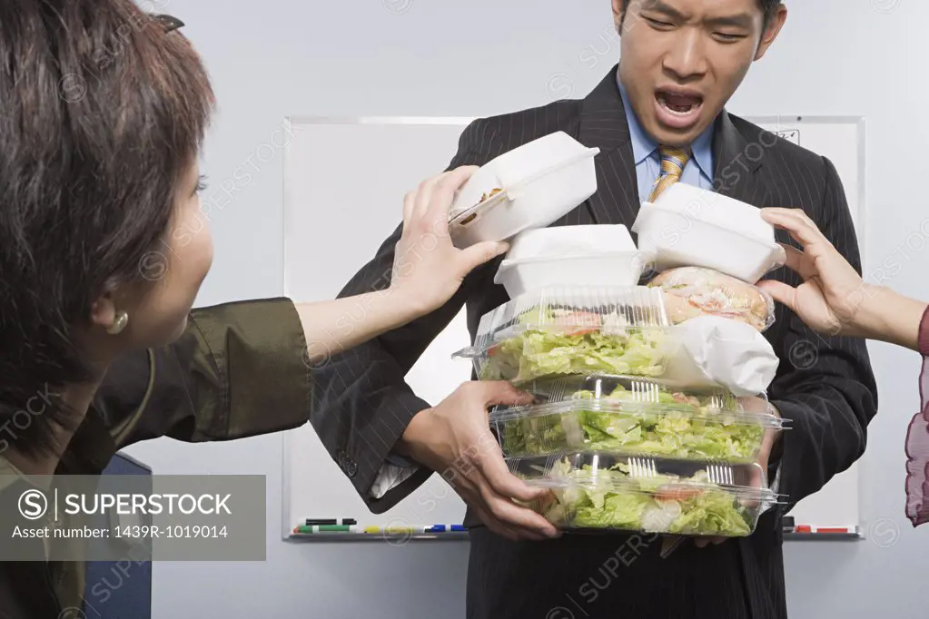 People taking food from colleague