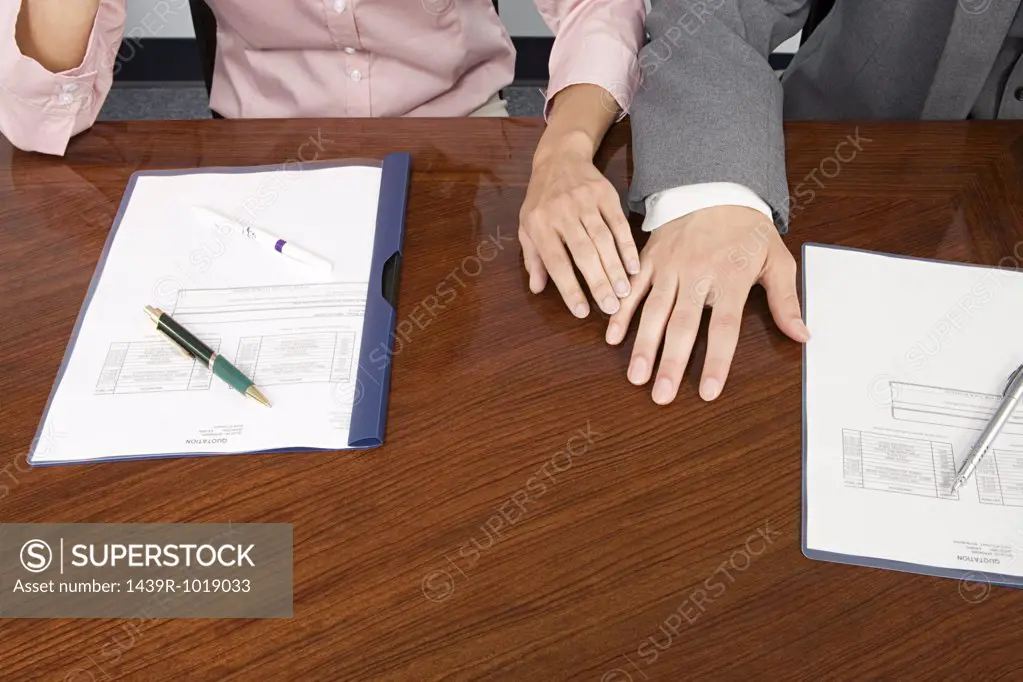 Colleagues hands touching