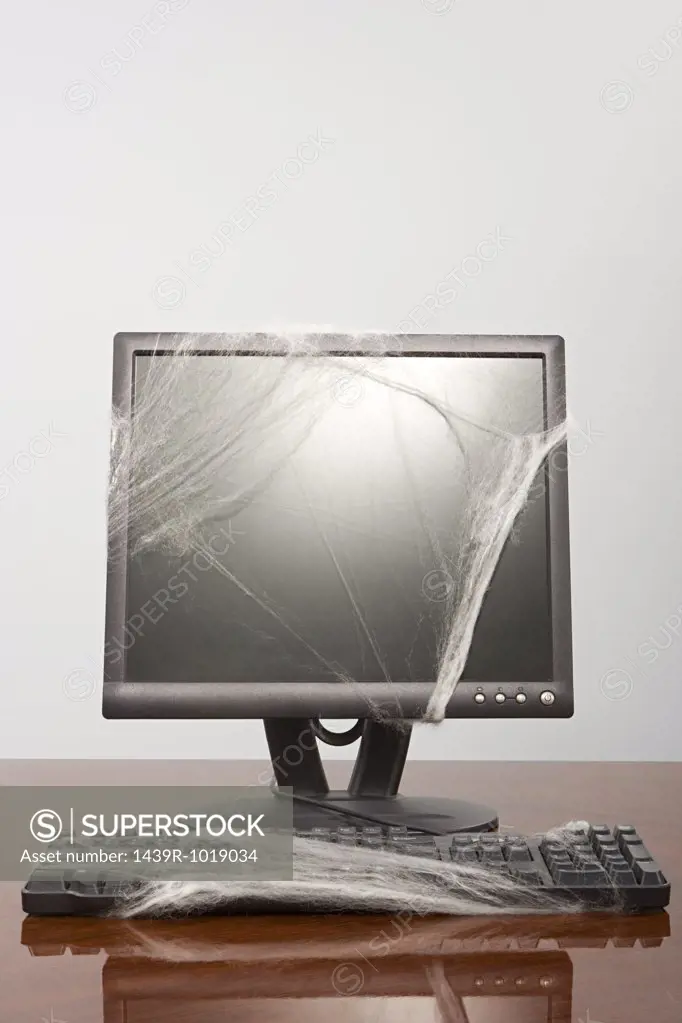 Computer covered in cobweb