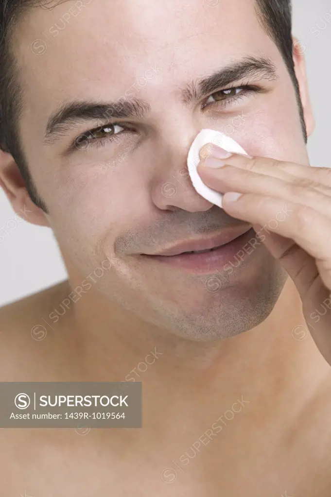Man cleaning his face