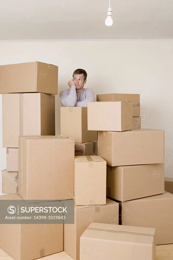 Man with stack of cardboard boxes
