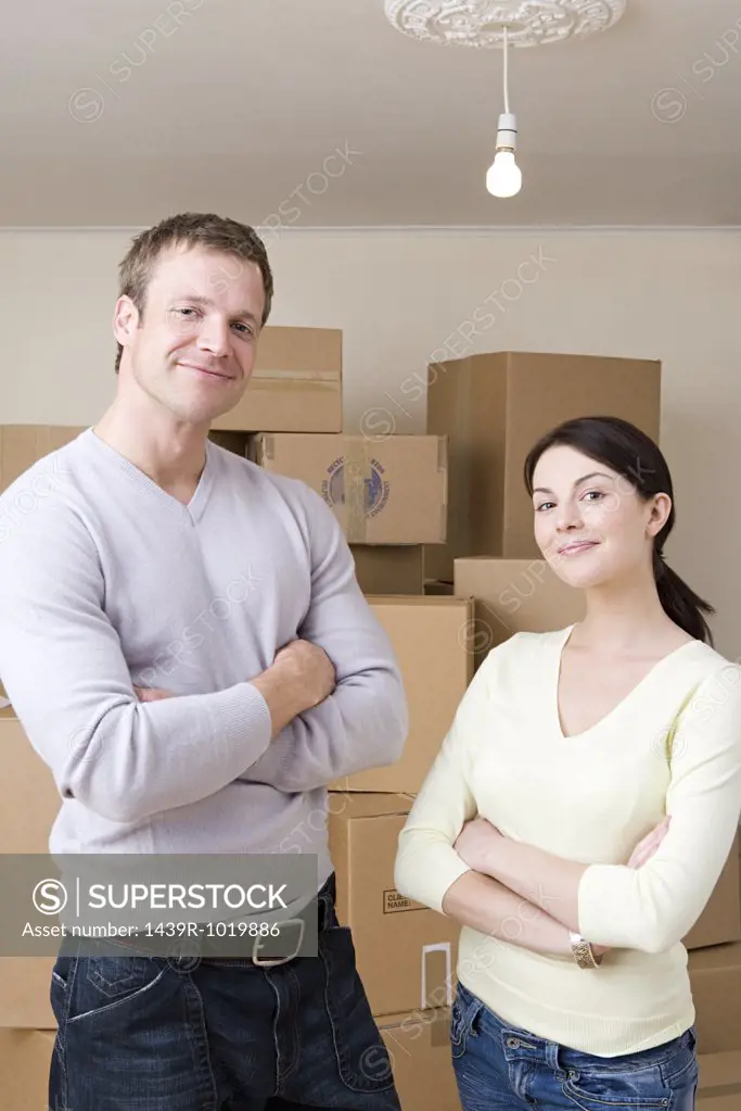 Couple by stack of cardboard boxes