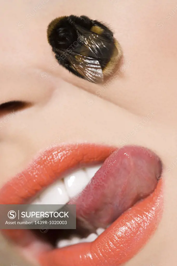 Woman with a bee on her face