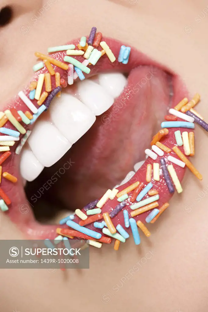 Woman with sugar sprinkles on her lips