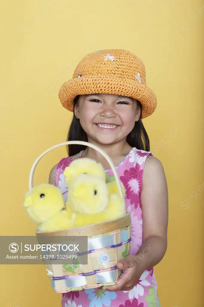 Girl holding a basket of chicks