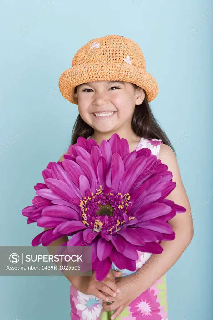 Asian girl holding a large flower