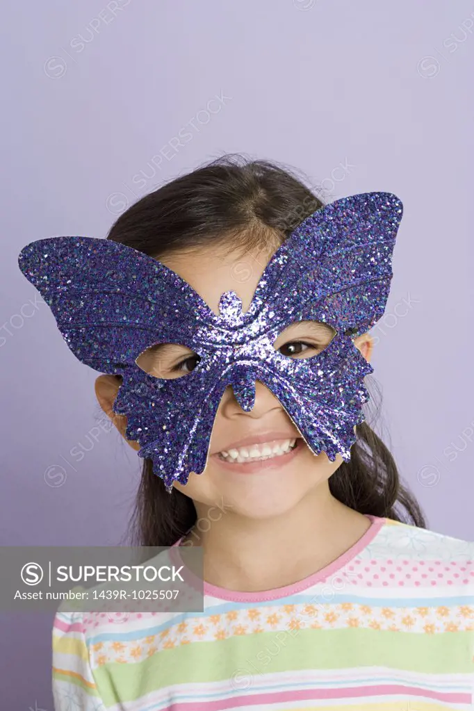 Girl wearing a butterfly eye mask