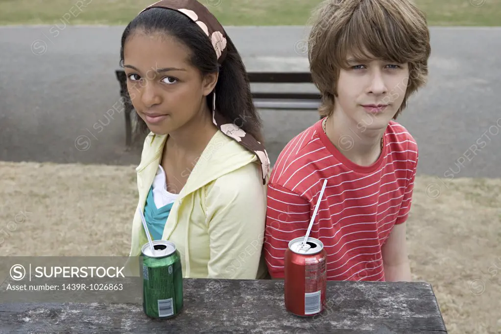 Teenage boy and girl with drinks