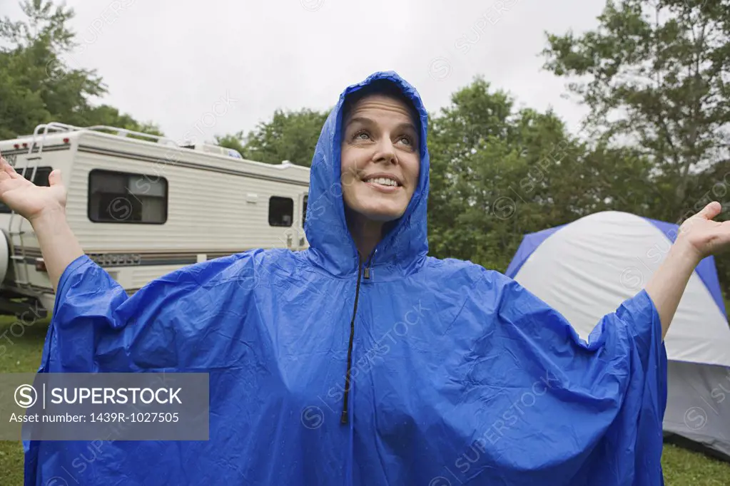 Woman wearing a blue plastic raincoat