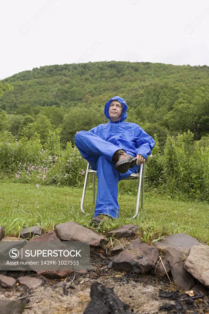 Mature man wearing a blue raincoat