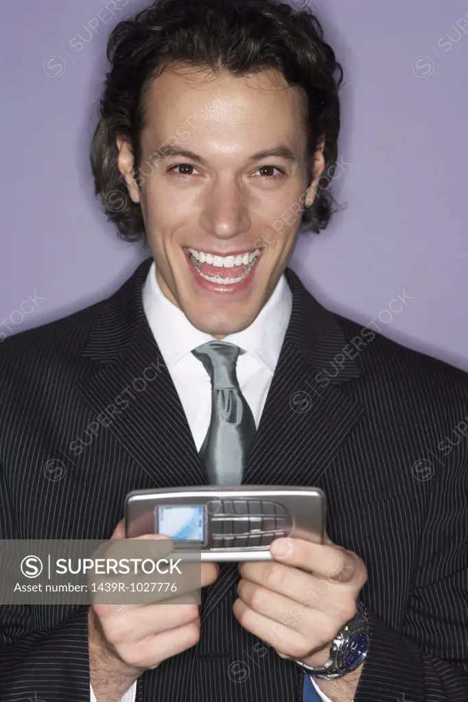 Excited businessman with cellphone