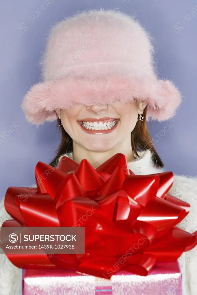 Fluffy hat covering womans face