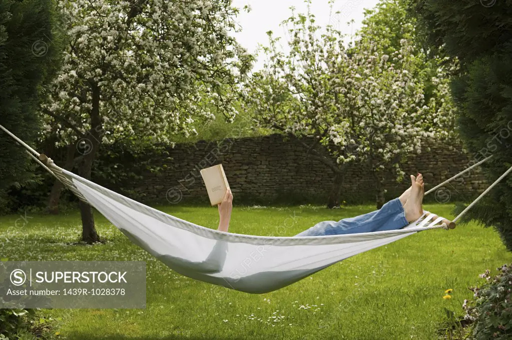 Woman in hammock reading book