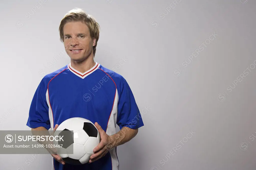 Footballer holding football