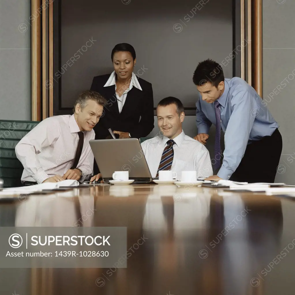 Businesspeople using a laptop computer