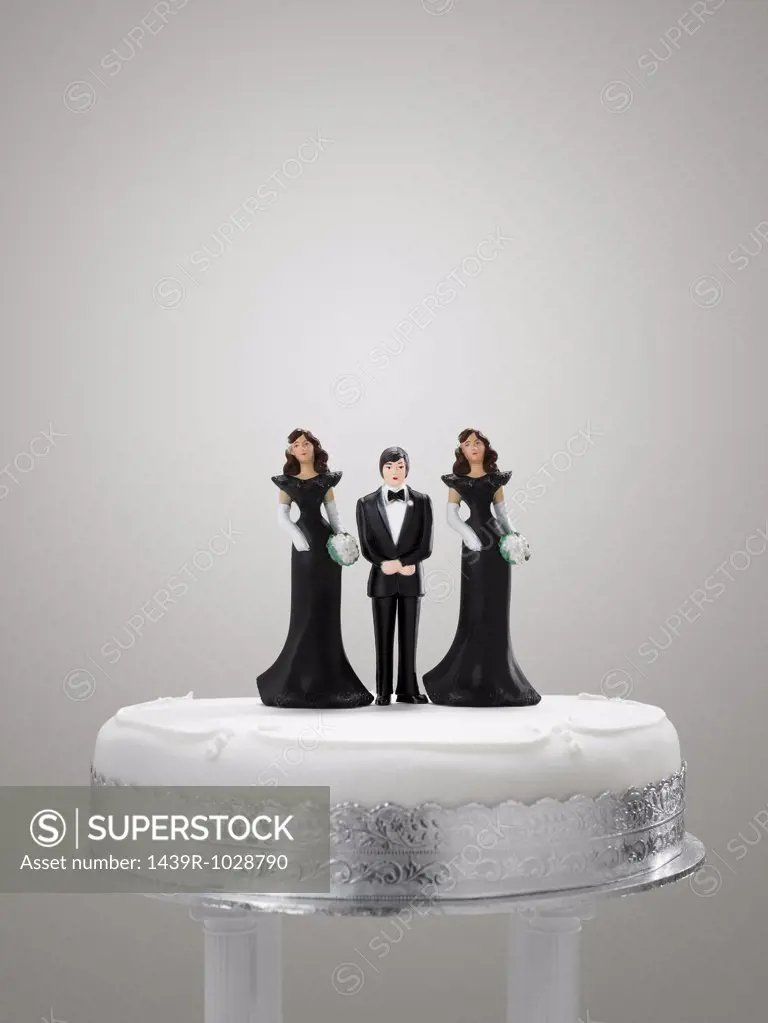 Bridegroom and bridesmaid figurines on a wedding cake
