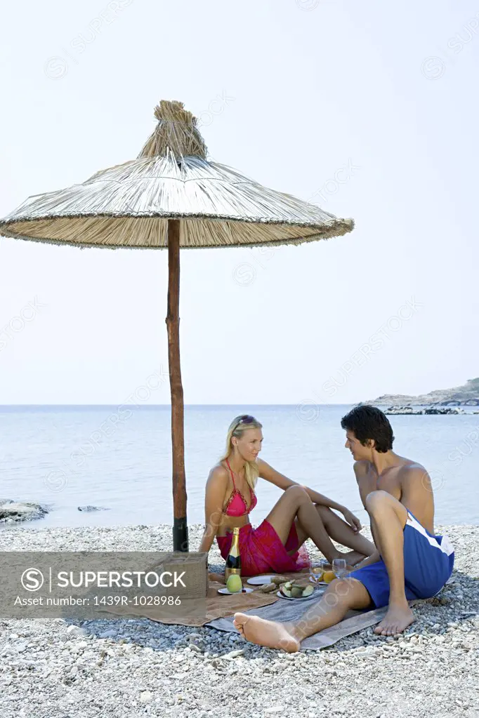 Couple having a picnic by the sea