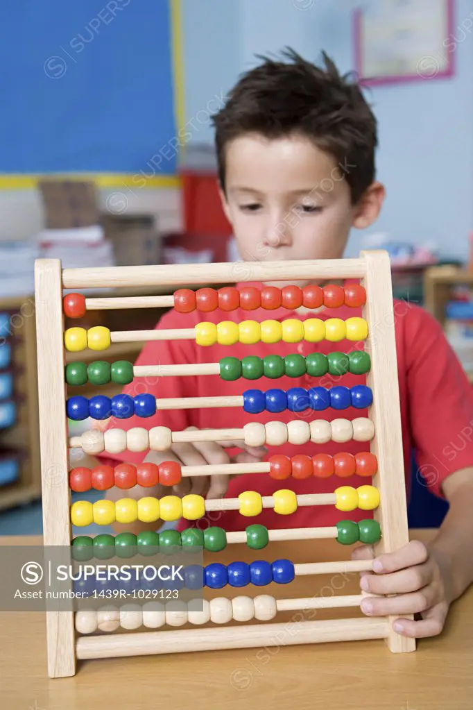 Boy counting on an abacus