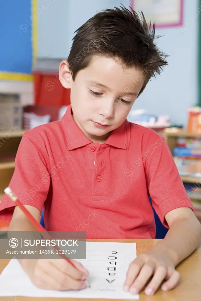 Boy writing alphabet