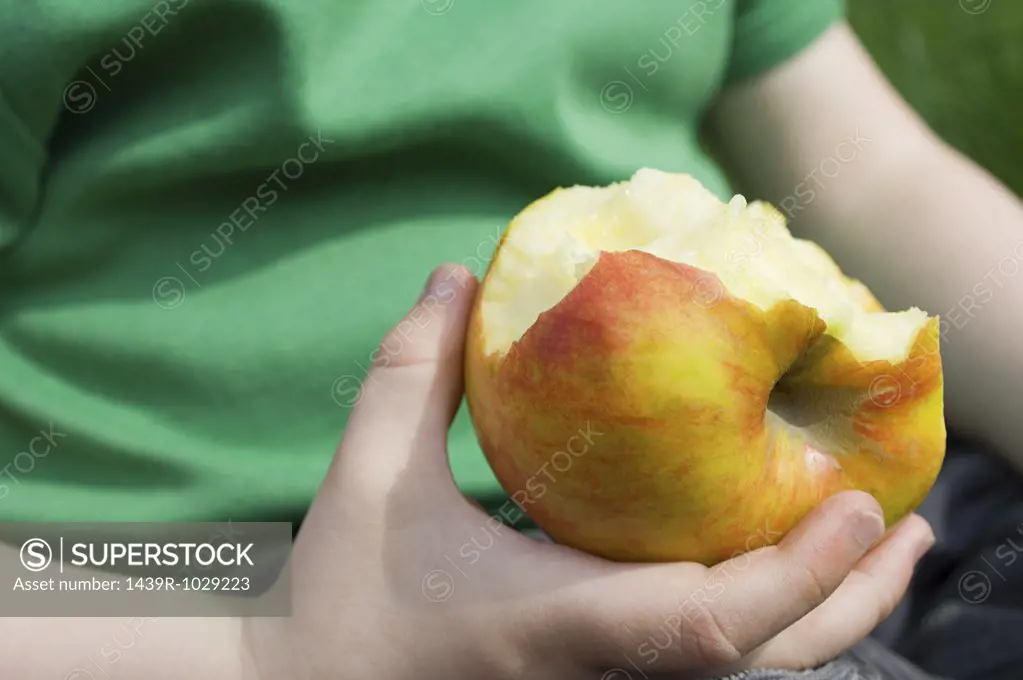 Child with an eaten apple