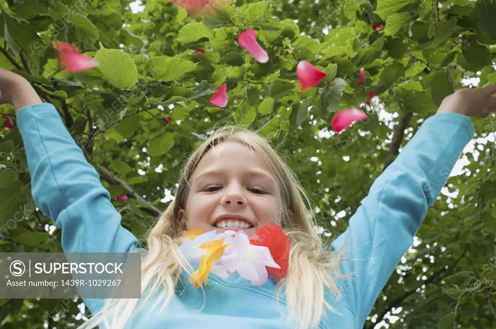 Girl throwing petals in the air
