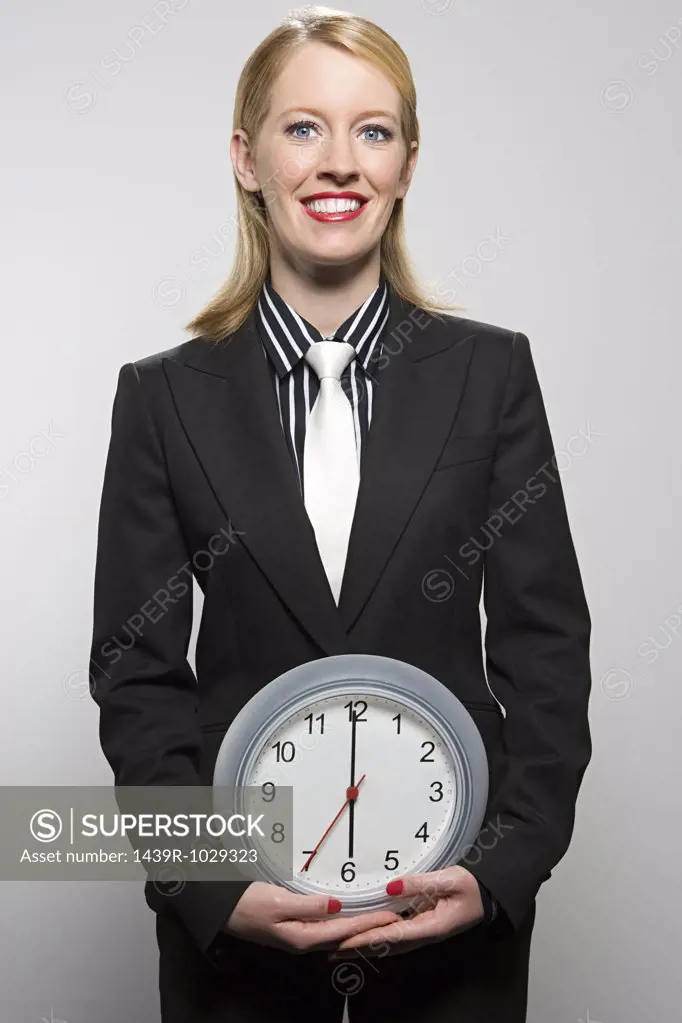 Businesswoman holding a clock