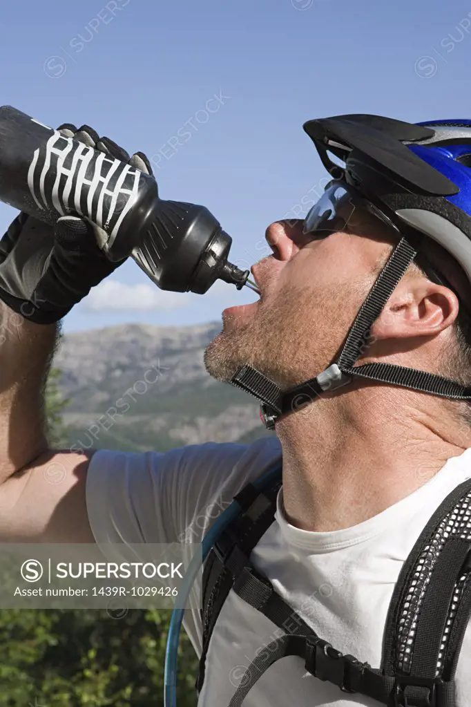 Mountain biker drinking from bottle