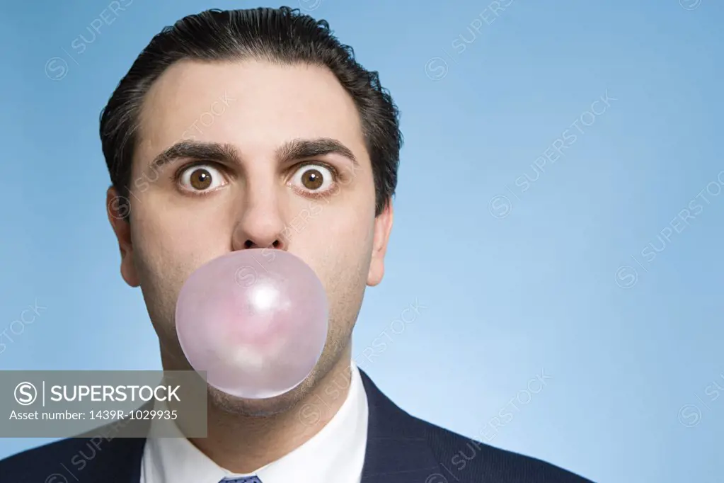 Man blowing bubble gum