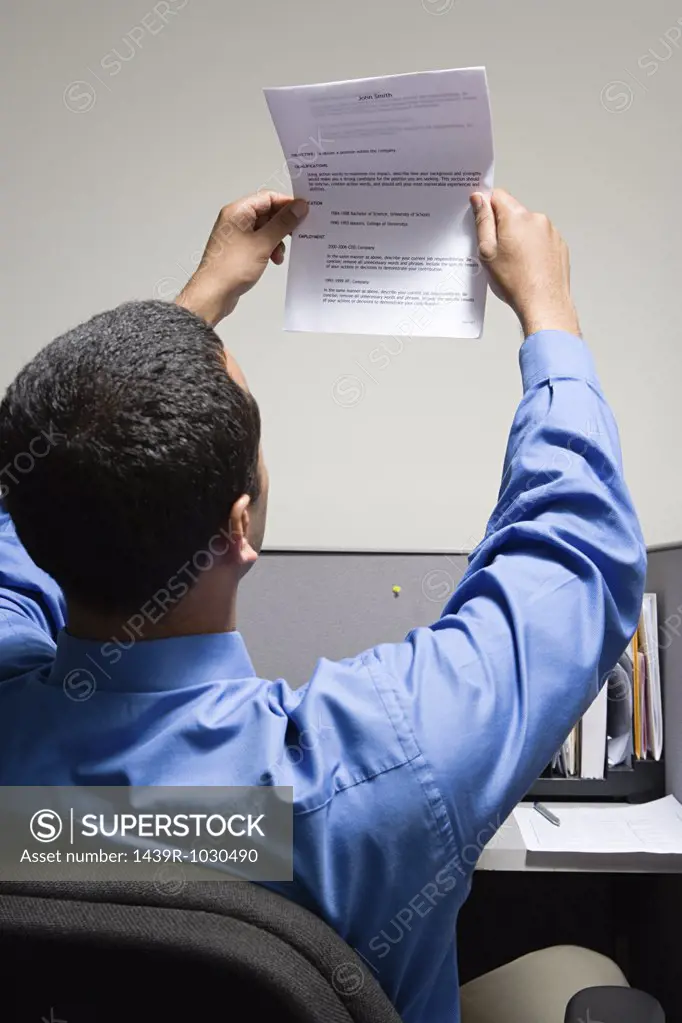 Man holding up his resume
